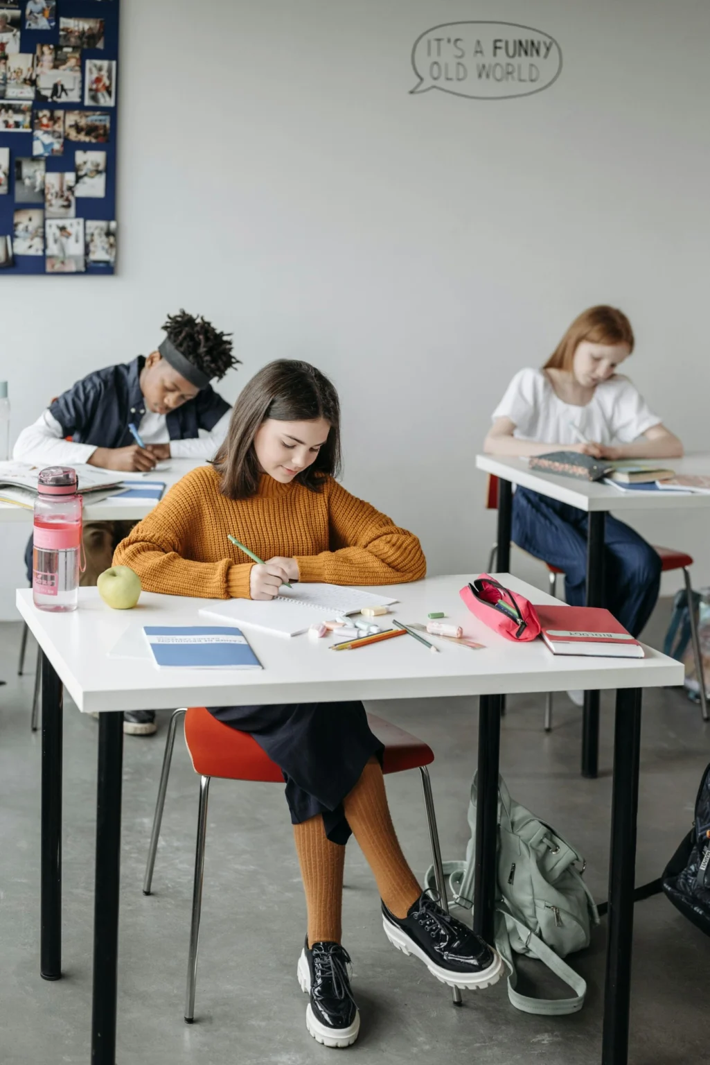 Students writing in notebooks during a classroom lesson at a secondary school Cracow